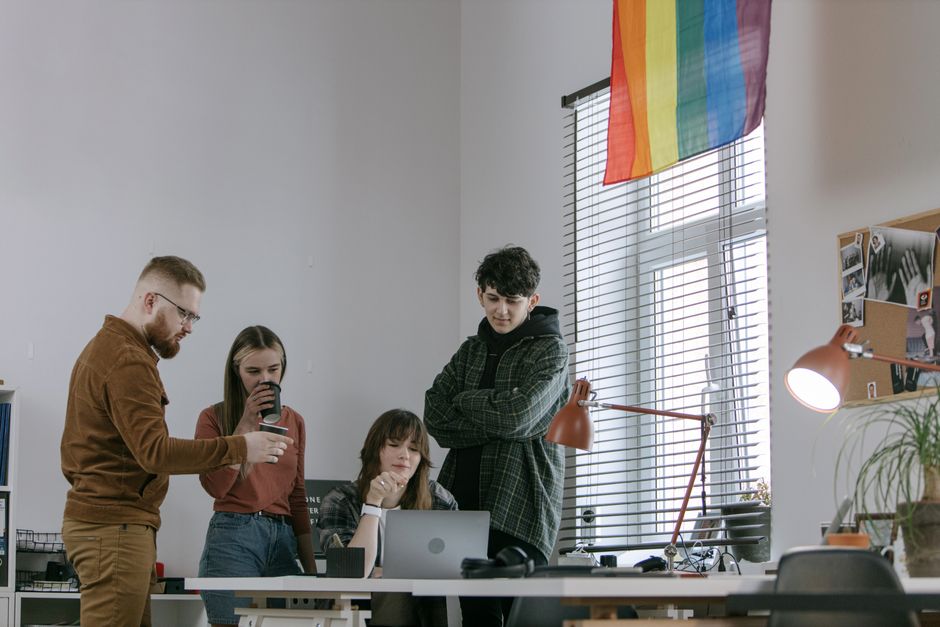 Young professionals collaborate in a creative office space, working together on a project.